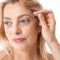 Woman,Correcting,Eyebrows,With,Tweezers,And,Looking,Away