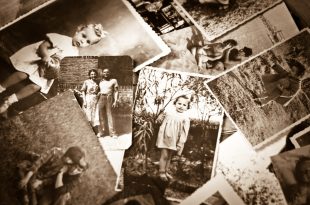 A pile of old black and white photographs