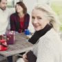 Portrait smiling senior woman at patio table
