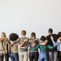 Rearview of diverse people hugging each other
